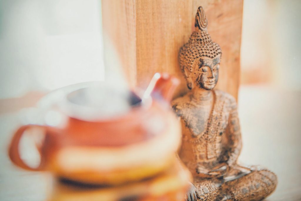 meditating buddha wooden statuette